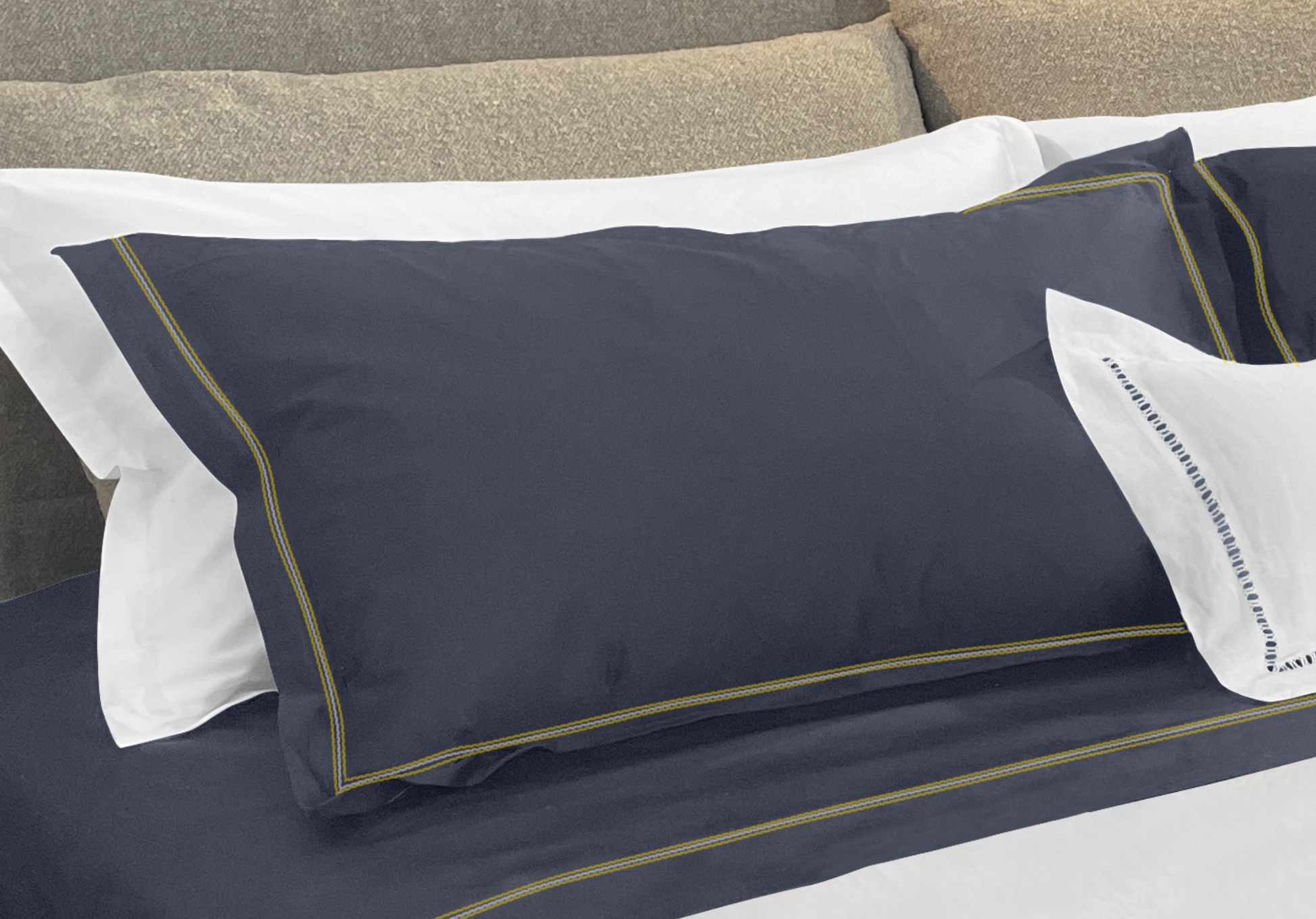 Narragansett Deep Sea Pillow Sham with a triple contrasting stitch in Yellow, White and Yellow. It is shown with our Daily Basics 300tc Egyptian Cotton Sateen Sleeping Sham in White.