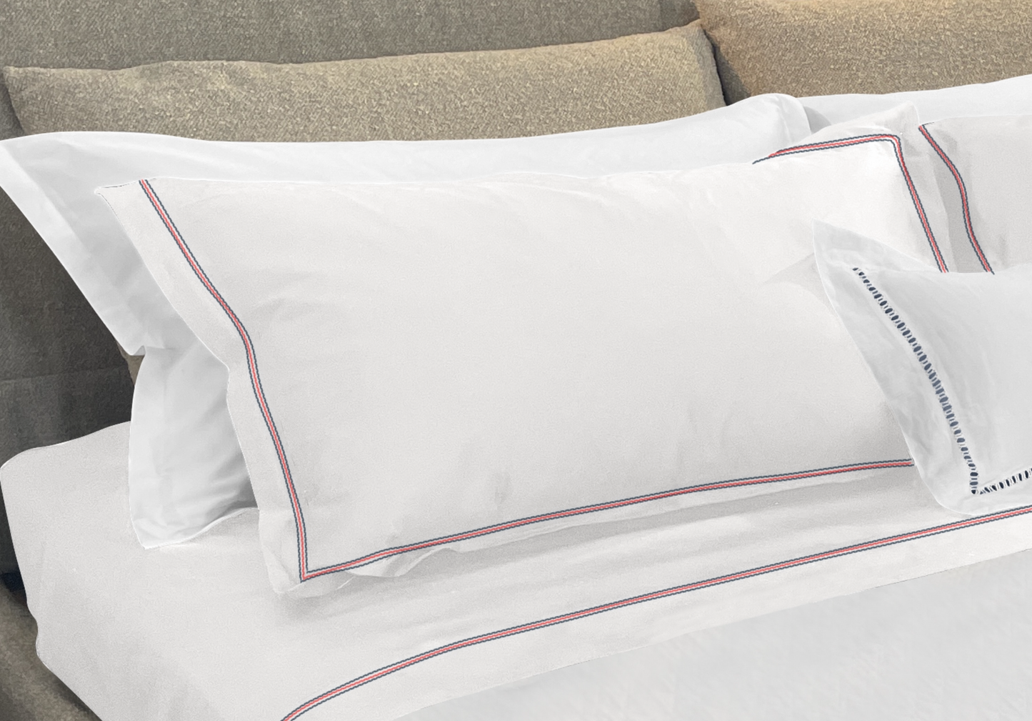 Narragansett White Pillow Sham with a triple contrasting stitch in Deep Sea, Red and Deep Sea. It is shown with our Daily Basics 300tc Egyptian Cotton Sateen Sleeping Sham in White. 