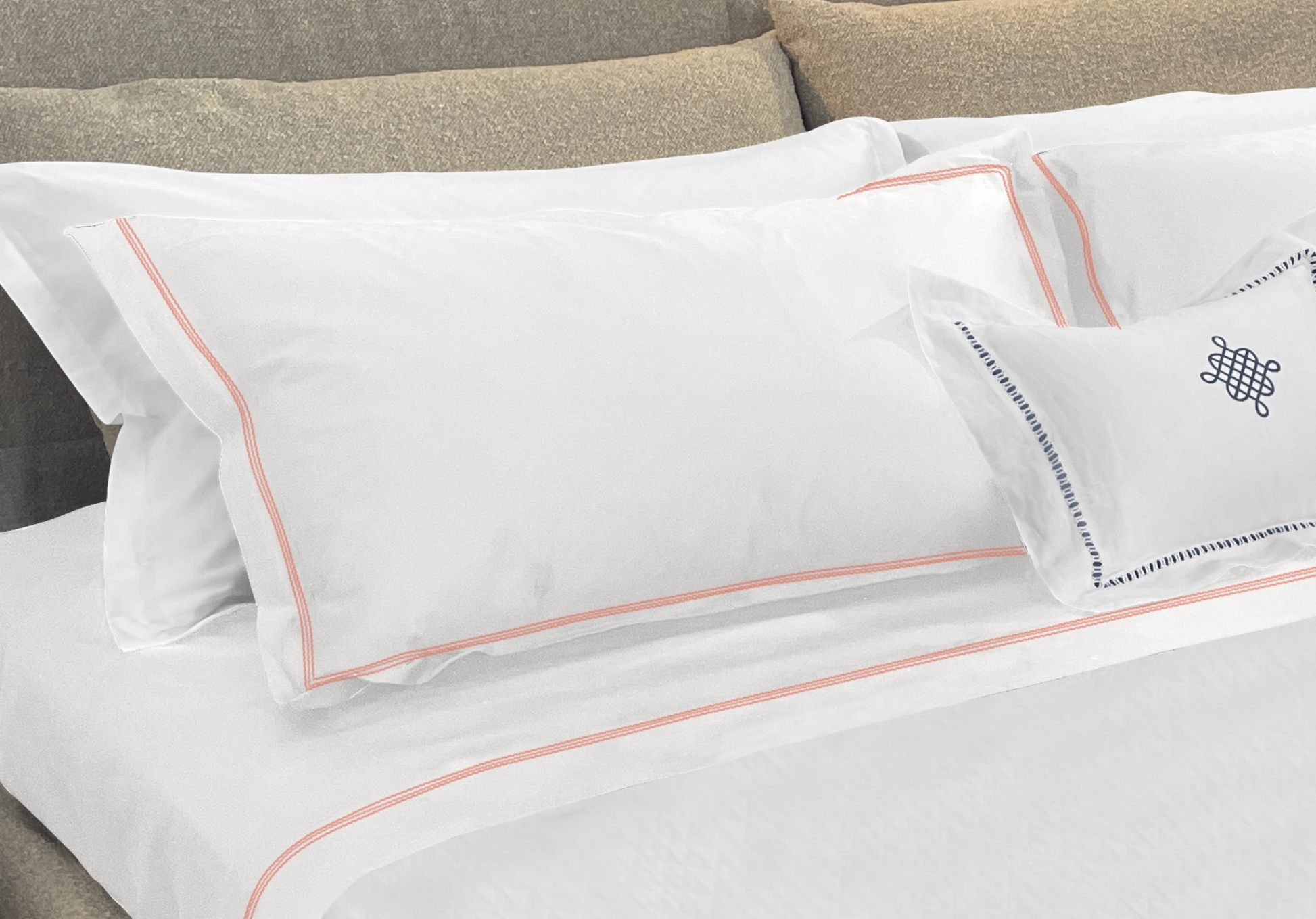 Narragansett White Pillow Sham with a triple contrasting stitch in Lobster. It is shown with our Daily Basics 300tc Egyptian Cotton Sateen Sleeping Sham in White. 