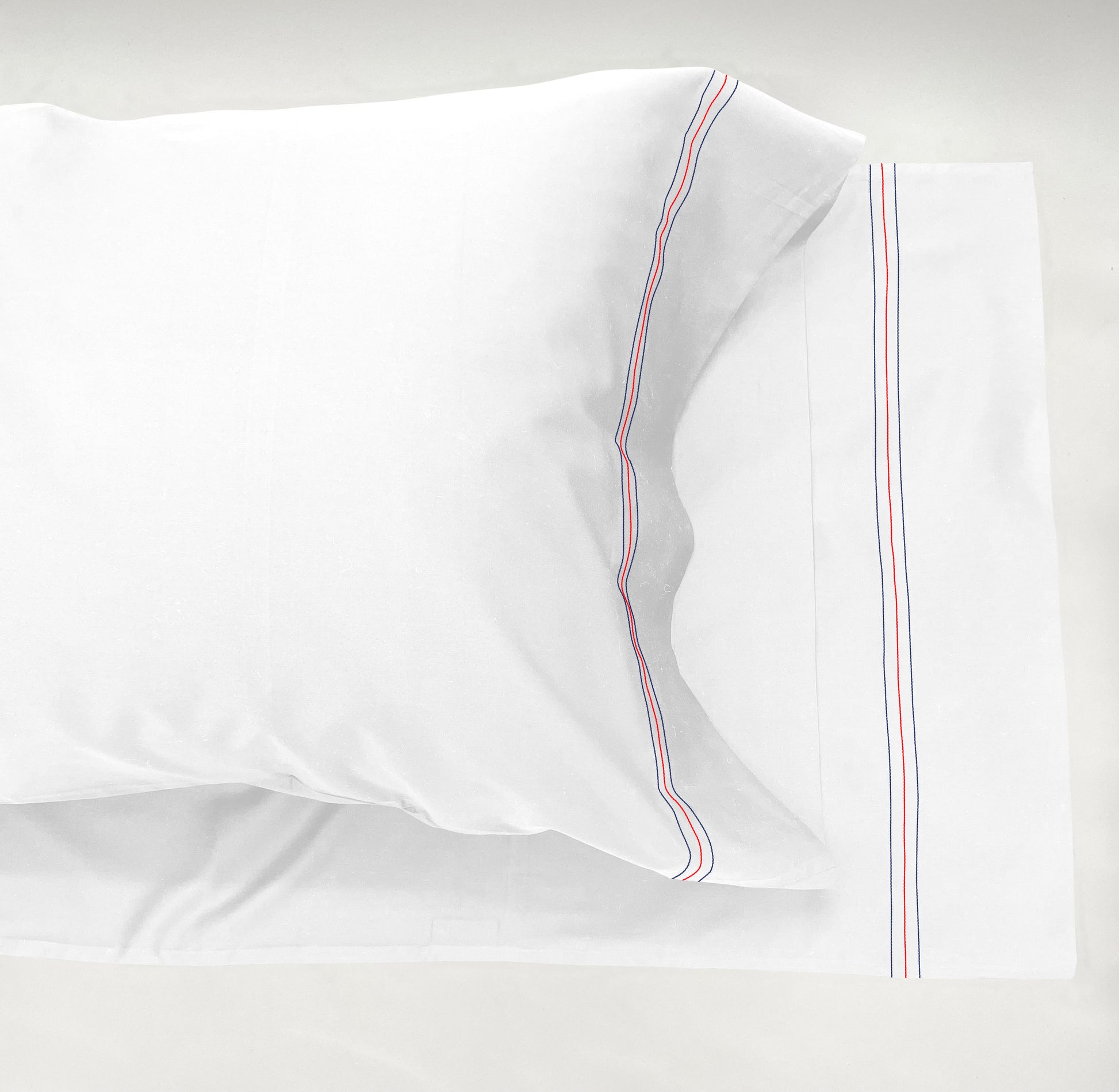 Narragansett White Pillow Case with a triple contrasting stitch in Deep Sea, Red and Deep Sea.